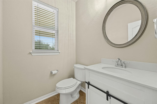 bathroom featuring tile patterned flooring, vanity, and toilet