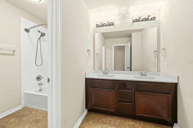 bathroom featuring vanity and tiled shower / bath