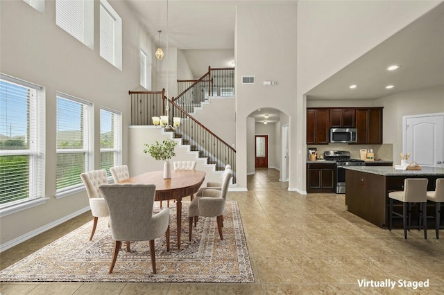 dining area with a high ceiling