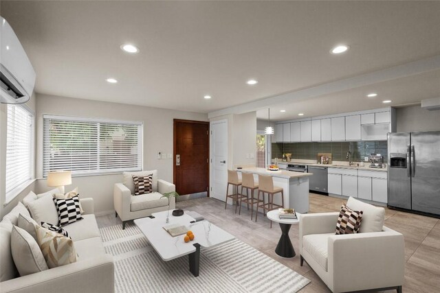 living room with sink, light tile floors, a wealth of natural light, and a wall mounted AC