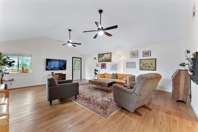 living room featuring vaulted ceiling, light hardwood / wood-style flooring, and ceiling fan