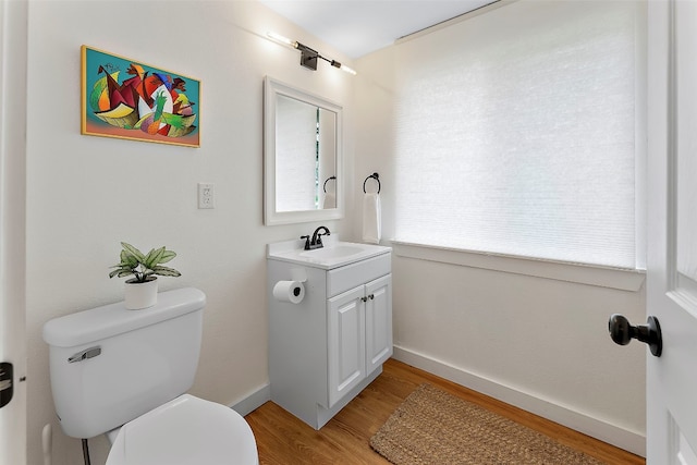 bathroom featuring vanity, toilet, and wood-type flooring