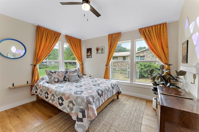 bedroom with light hardwood / wood-style floors and ceiling fan