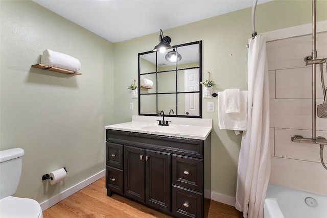 full bathroom with vanity, shower / tub combo, hardwood / wood-style flooring, and toilet