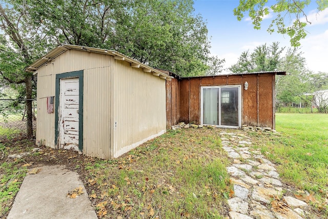 view of outbuilding featuring a lawn