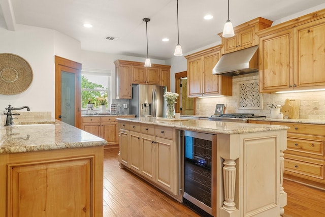 1451 Gatlin Creek Rd E, Driftwood, TX 78619 - kitchen featuring beverage cooler, stainless steel fridge with ice dispenser, pendant lighting, a kitchen island, and sink