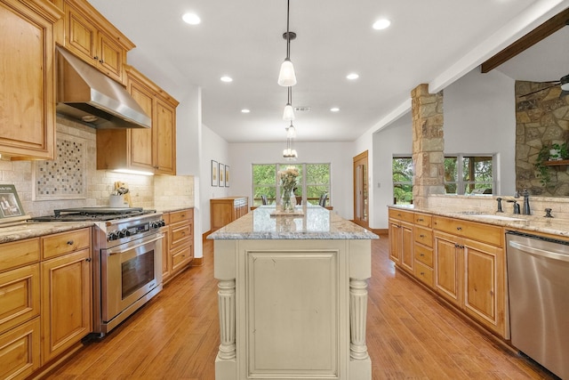 1451 Gatlin Creek Rd E, Driftwood, TX 78619 - kitchen with stainless steel appliances, light stone countertops, pendant lighting, a kitchen island, and sink