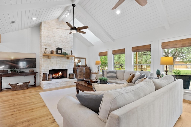 1451 Gatlin Creek Rd E, Driftwood, TX 78619 - living room featuring wooden ceiling, a fireplace, light hardwood / wood-style floors, high vaulted ceiling, and beam ceiling