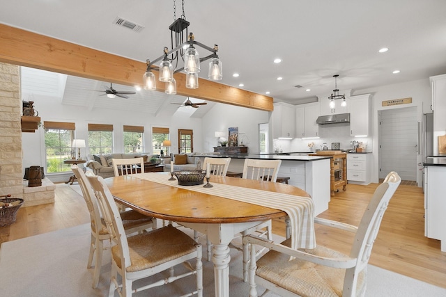 1451 Gatlin Creek Rd E, Driftwood, TX 78619 - dining room featuring light hardwood / wood-style floors, ceiling fan, and vaulted ceiling with beams