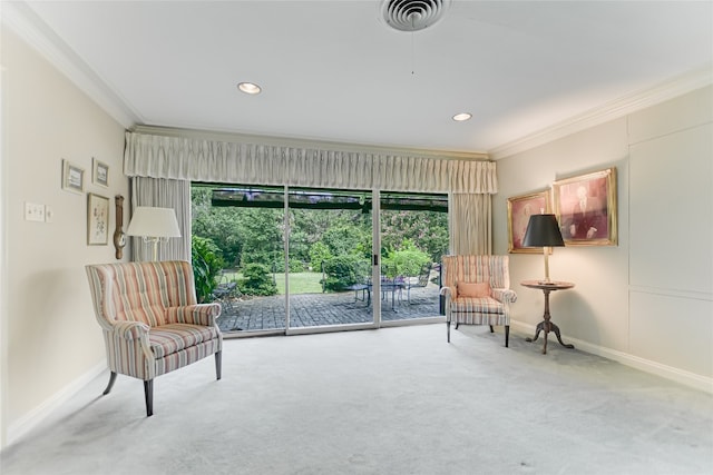 sitting room with carpet floors and crown molding