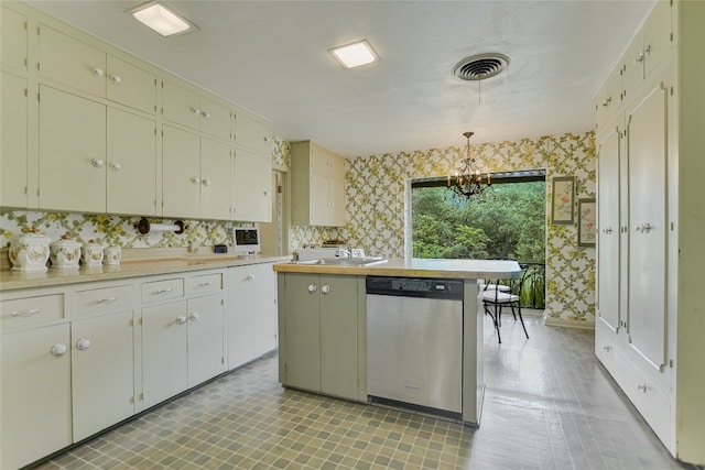 kitchen featuring white cabinets, sink, pendant lighting, an inviting chandelier, and dishwasher