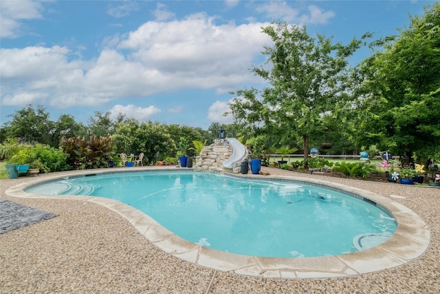 view of pool with a water slide