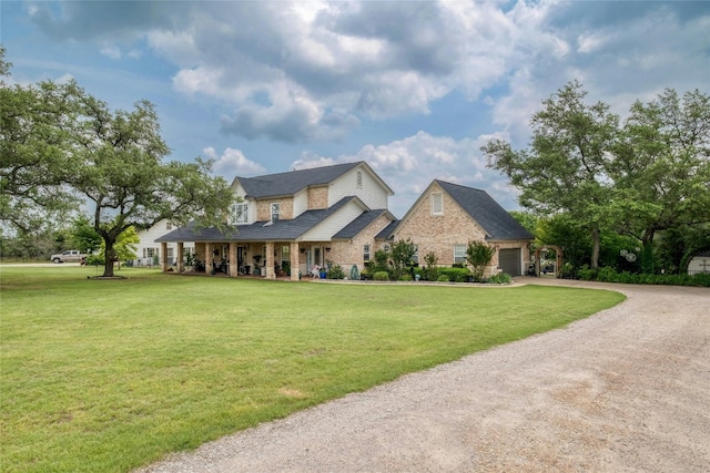 view of front of property featuring a front yard and a garage