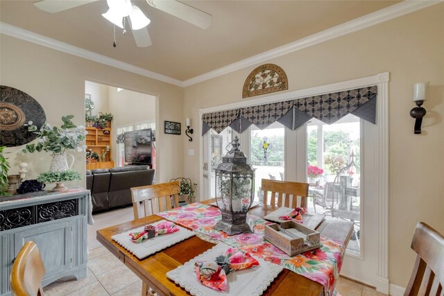 tiled dining space featuring ceiling fan and crown molding