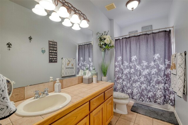 full bathroom with tile patterned flooring, vanity, shower / bath combination with curtain, and toilet