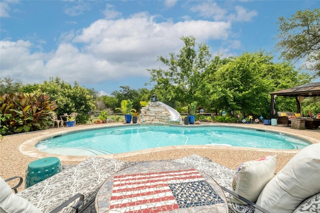 view of pool with a gazebo, a patio area, and a water slide