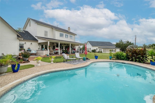 view of pool with a lawn and a patio area