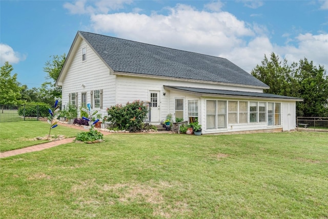 back of house featuring a lawn