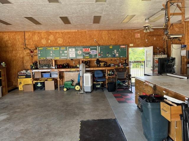 garage with a workshop area and ceiling fan