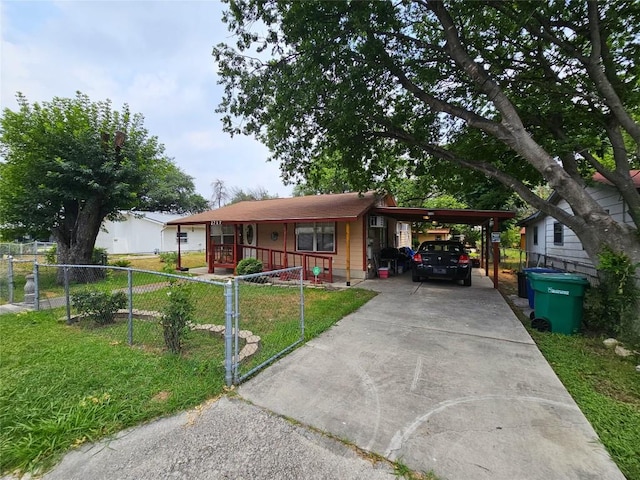 single story home with covered porch, a front yard, and a carport