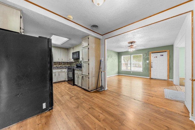 kitchen featuring ceiling fan, light hardwood / wood-style flooring, tasteful backsplash, black appliances, and a textured ceiling