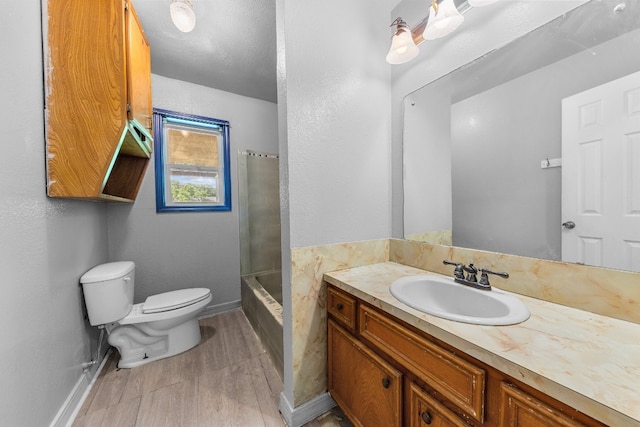 full bathroom featuring bathtub / shower combination, hardwood / wood-style flooring, toilet, and vanity