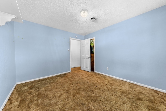 spare room with carpet flooring and a textured ceiling