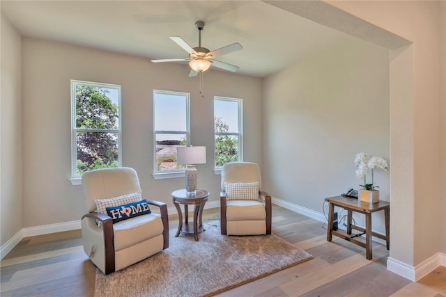 sitting room featuring ceiling fan and wood-type flooring