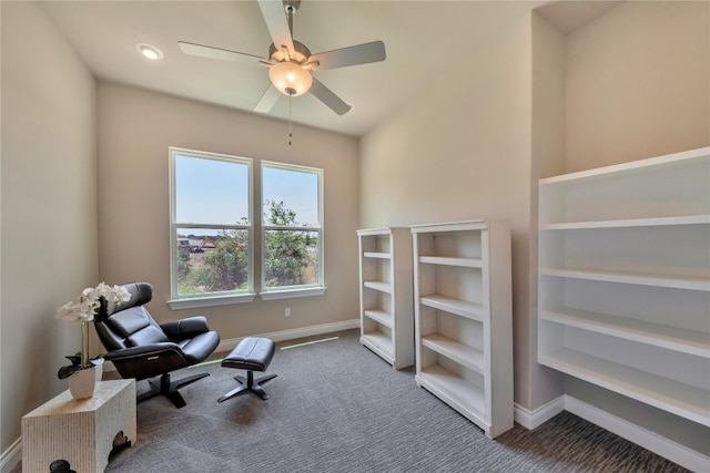 living area featuring carpet flooring and ceiling fan