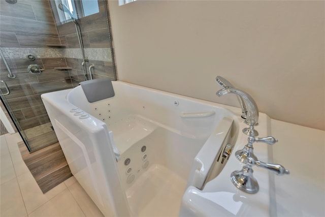 bathroom featuring tile floors and a bathtub