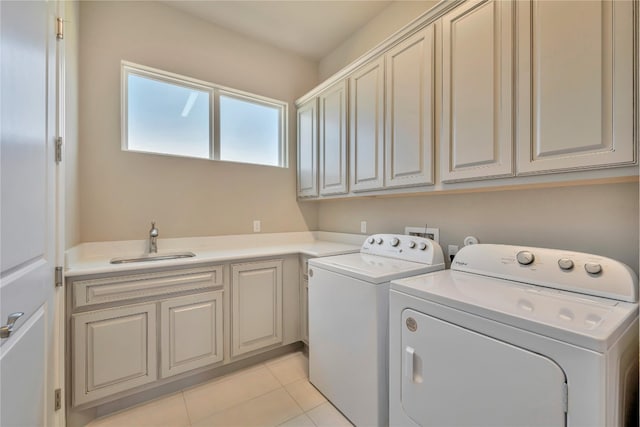 laundry area featuring washer and dryer, cabinets, washer hookup, sink, and light tile floors