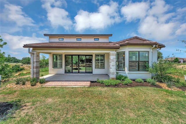 rear view of property with a patio area and a yard