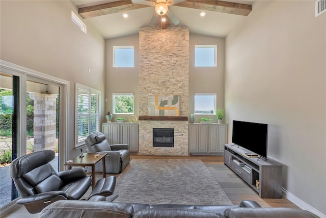 living room with beamed ceiling, ceiling fan, light hardwood / wood-style flooring, and high vaulted ceiling