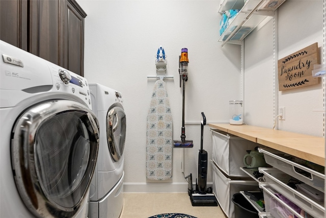 laundry area with light tile patterned floors and separate washer and dryer