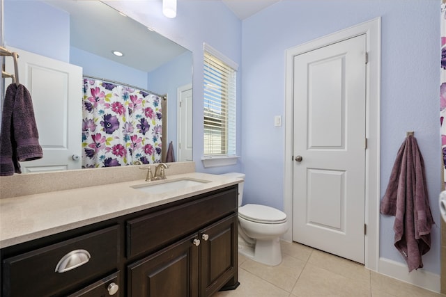 bathroom featuring toilet, vanity, and tile patterned floors