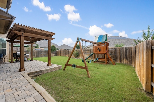 view of play area with a yard, a patio area, and a pergola