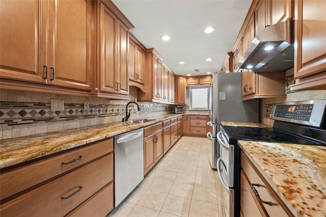 kitchen with appliances with stainless steel finishes, light tile patterned floors, extractor fan, and light stone counters