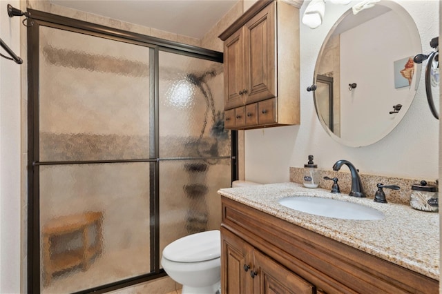 bathroom with vanity, toilet, and walk in shower