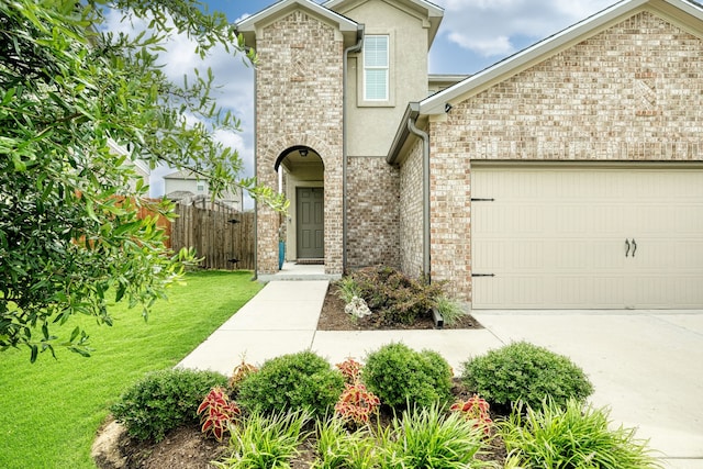 front facade featuring a garage and a front lawn