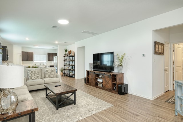 living room with light hardwood / wood-style flooring