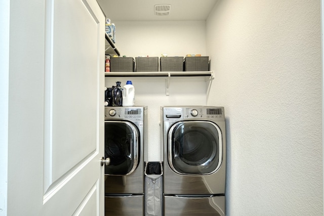 laundry room featuring washing machine and dryer