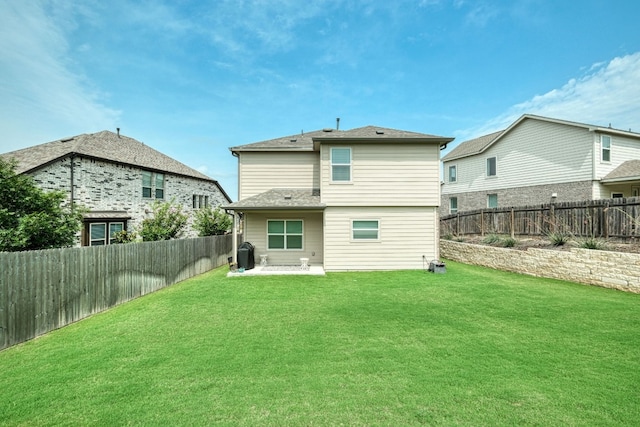 back of house featuring a lawn and a patio