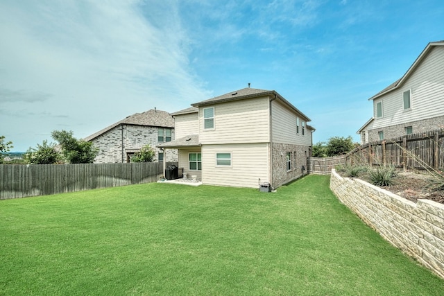 back of house with a lawn