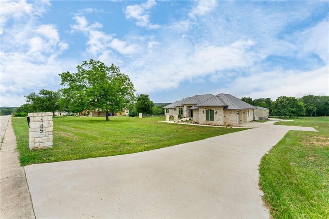 view of front of property with driveway and a front lawn