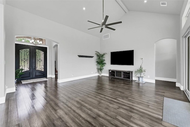 unfurnished living room featuring high vaulted ceiling, arched walkways, french doors, and visible vents