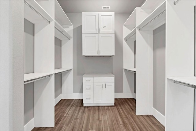 spacious closet with wood finished floors and visible vents