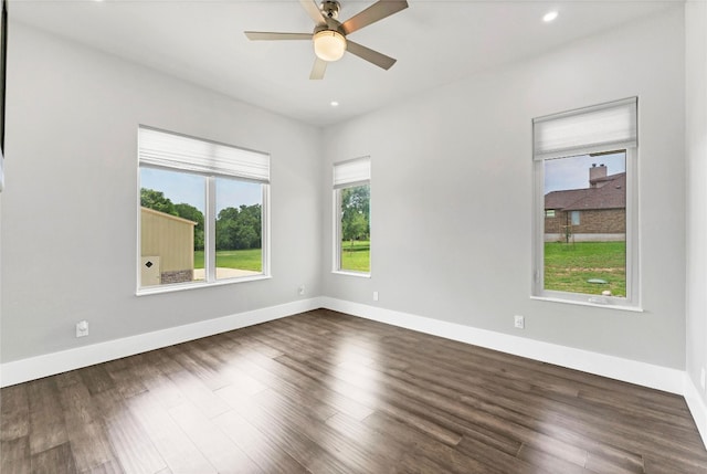 unfurnished room with ceiling fan and dark hardwood / wood-style floors