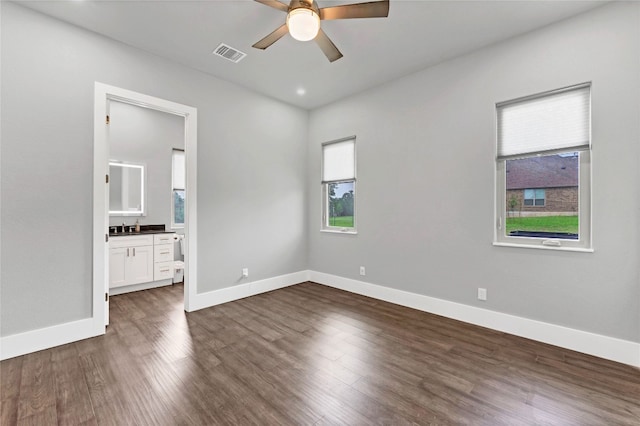 unfurnished room with ceiling fan, dark hardwood / wood-style floors, and sink