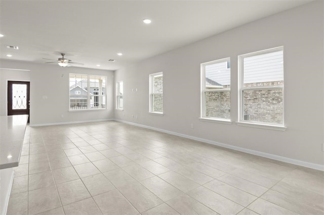 unfurnished room with ceiling fan and light tile patterned flooring