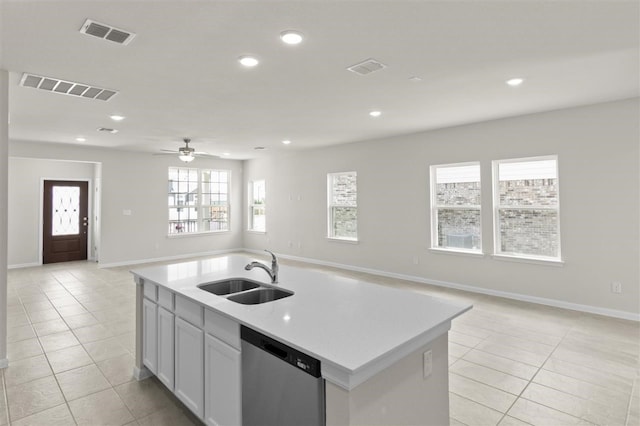 kitchen with ceiling fan, dishwasher, sink, a kitchen island with sink, and light tile patterned floors